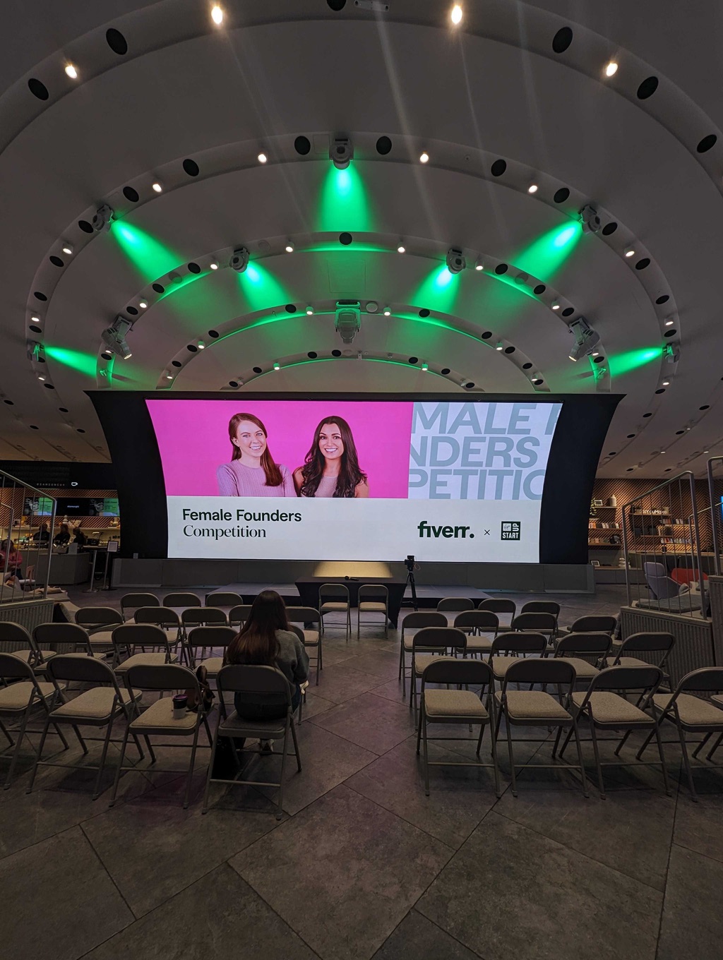 The identity on screens around the room