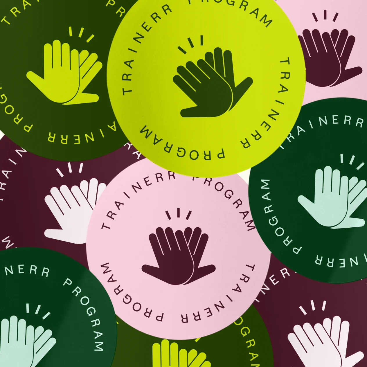 Trainerr Program logo as a pile of high-five stickers